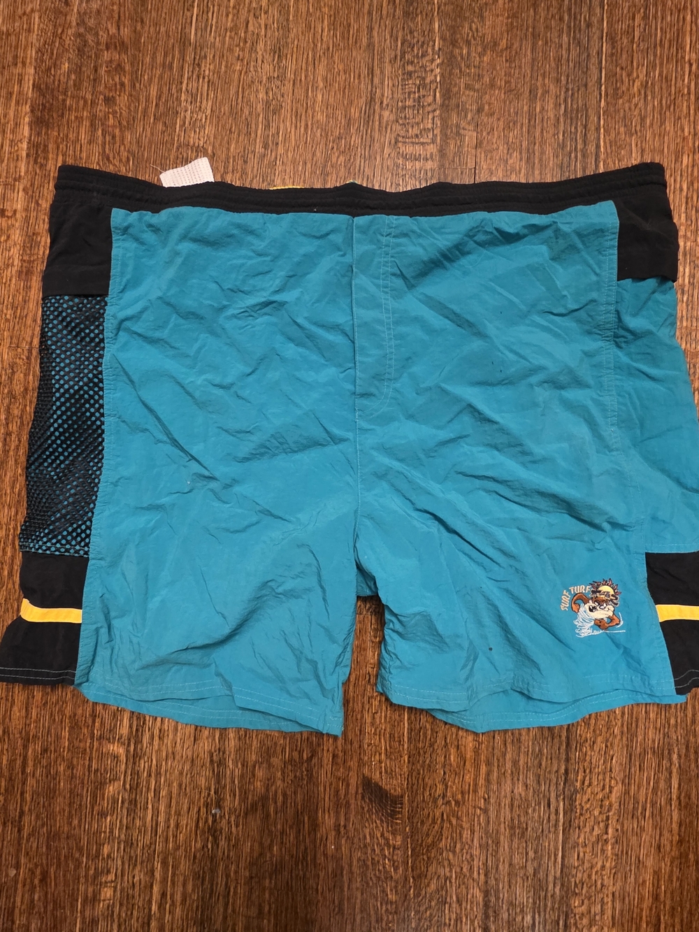 Warner Bros. Teal Swim Shorts with Black Trim and Yellow Accent